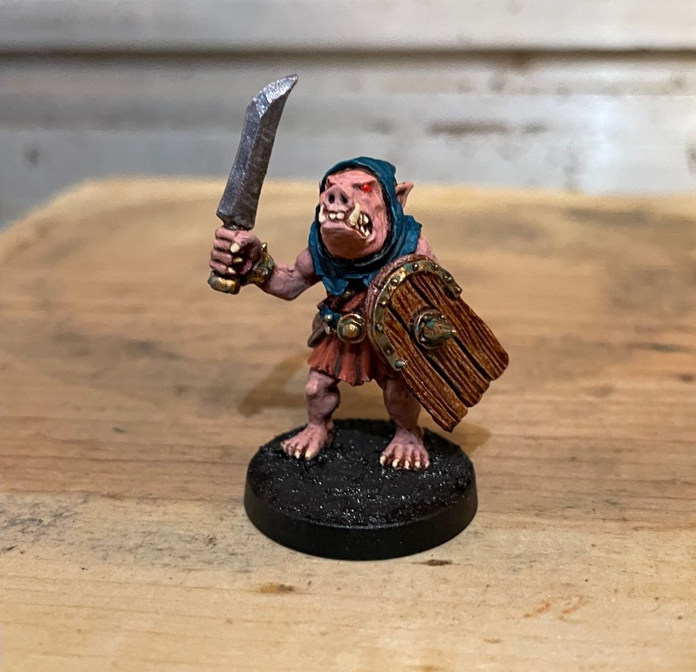 An AD&D-style pig-faced orc miniature, sculpted by Kev Adams.