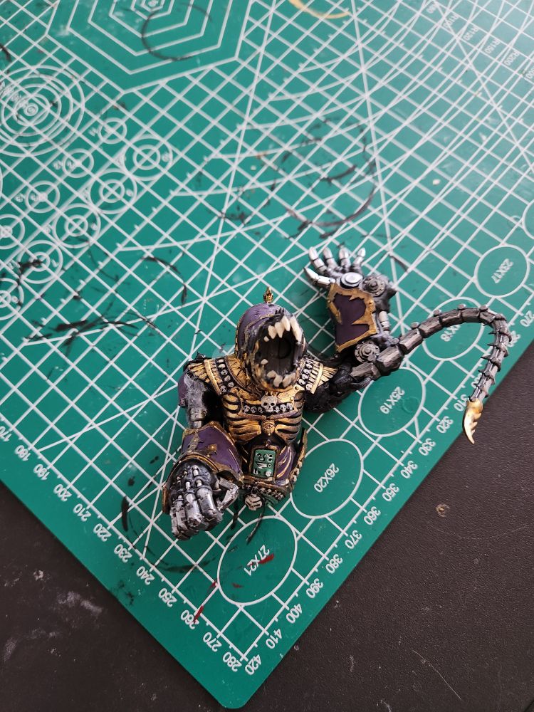 Top half of the miniature, the human like part of a sphinx but it's head is replaced with mechanical parts. It's hands are also mechanical fists.