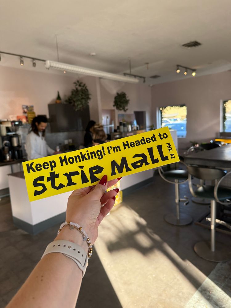 bumper sticker from phoenix’s hottest coffee shop that says Keep Honking! I’m Headed To Strip Mall 