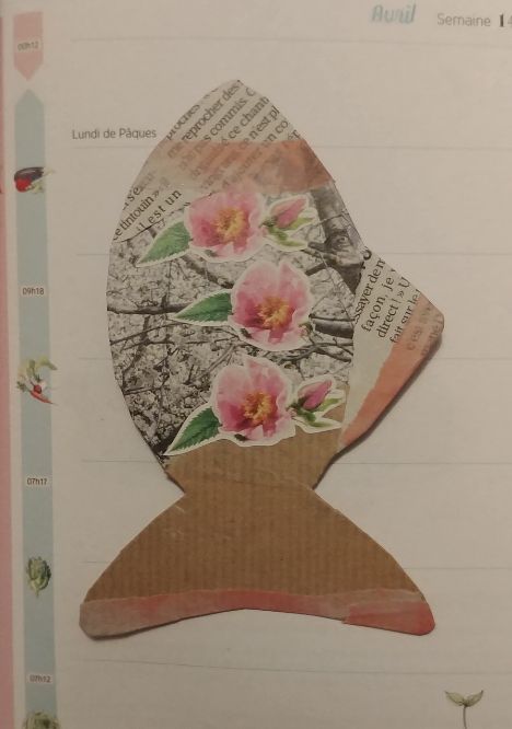 A cupboard cutout of a fish with collage elements on it (flower pictures from a magazine, brown paper, newspaper bits, washi tape, etc...)
The vibe is pink and soft and spring-like.
