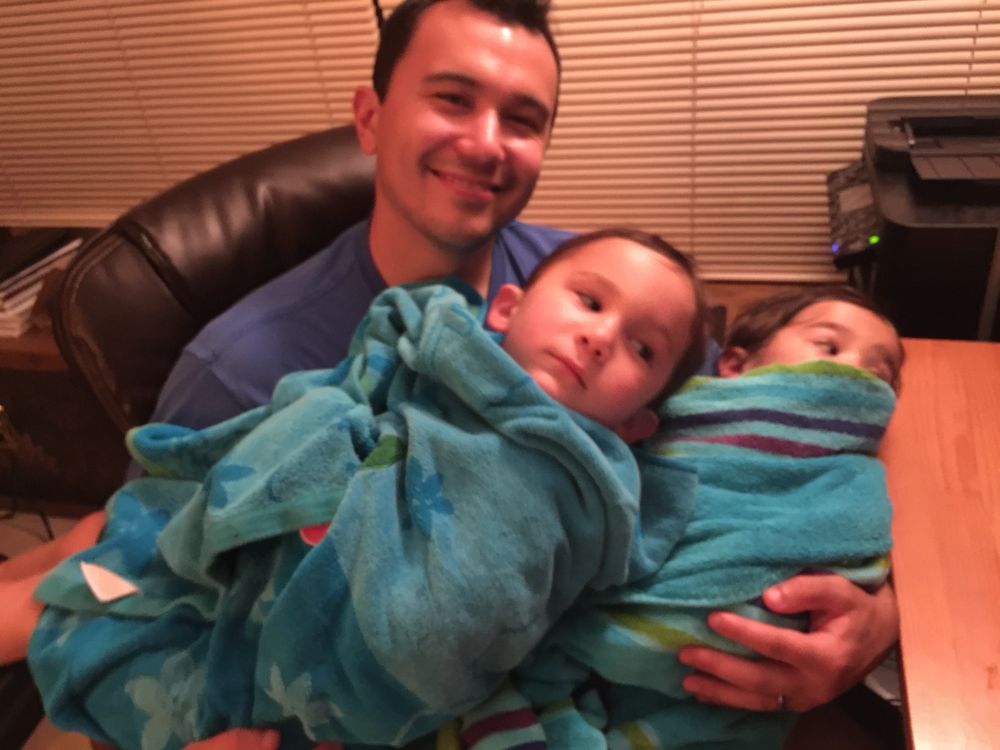 It’s me with my beautiful babies wrapped up in towels and snuggled up tight. I’d bet I was playing video games with how the kids are staring at where my desk monitors would be. 