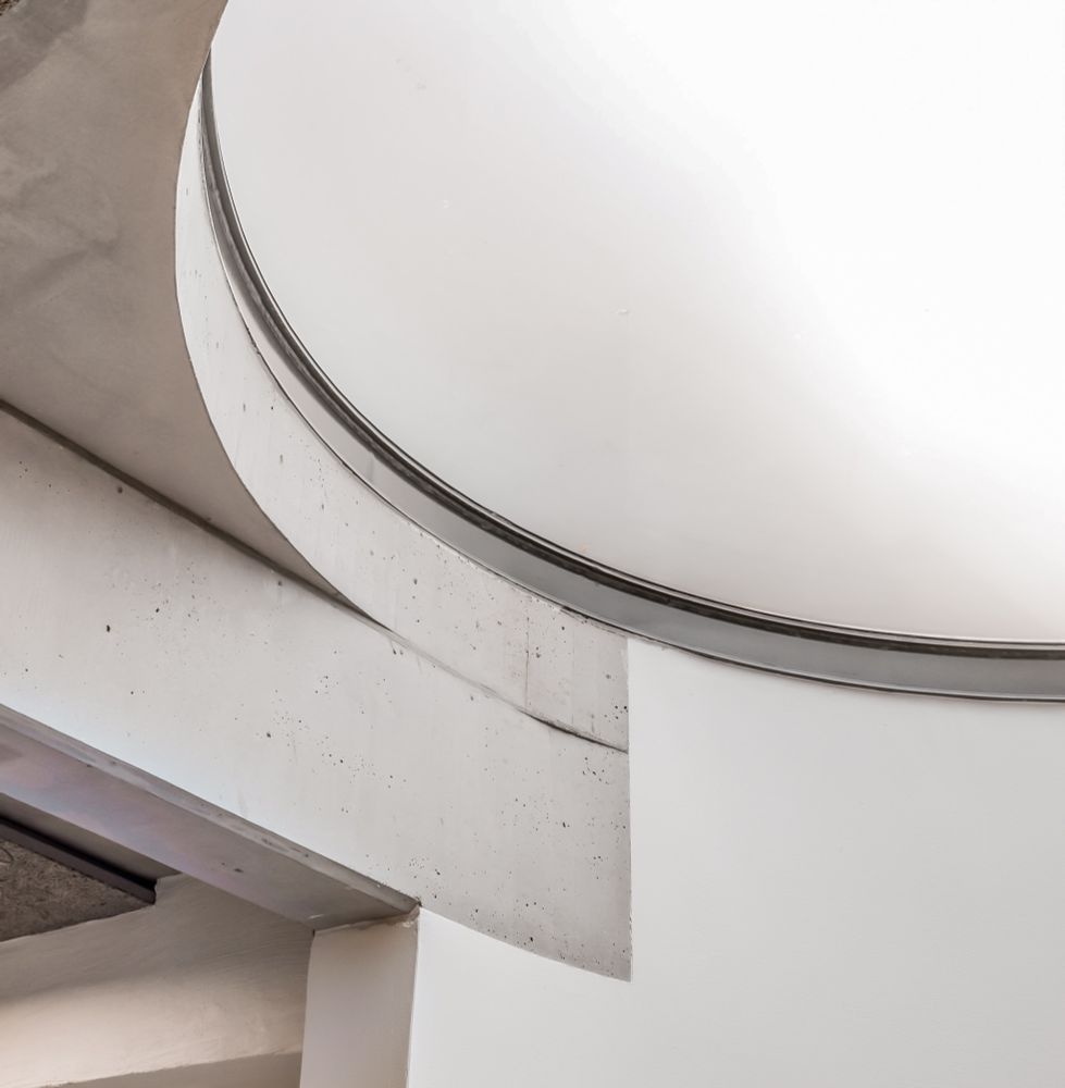 An image showing the interplay of form, material and light: a circular skylight of our deisgn from 2014, as seen from below.