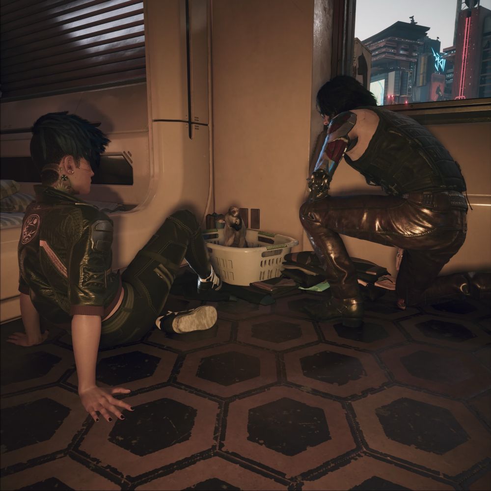 V sitting and Johnny kneeling next to the hamper that is holding nibbles.