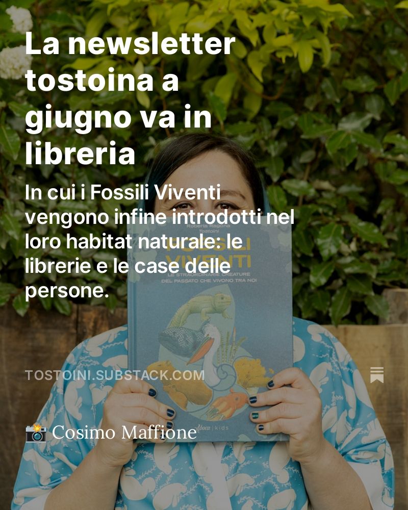card di preview della newsletter tostoina di giugno con una foto di tostoini sorridente che regge una copia di fossili viventi e la scritta "la newsletter tostoina a giugno va in libreria - in cui i fossili viventi vengono finalmente introdotti nel loro habitat naturale: le librerie e le case delle persone." foto di cosimo maffione