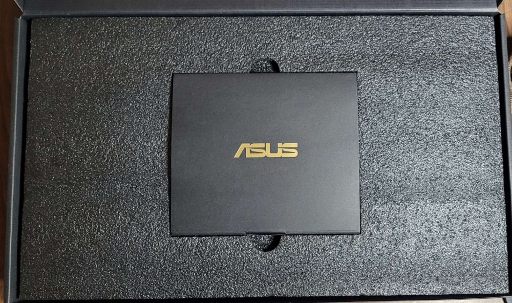 A black box with a small card in the middle labelled with "Asus"
