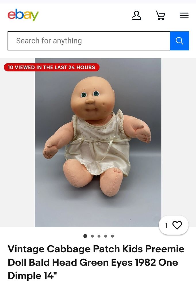 Photo of a vintage, cloth body newborn / "preemie" cabbage patch doll with a bald head.