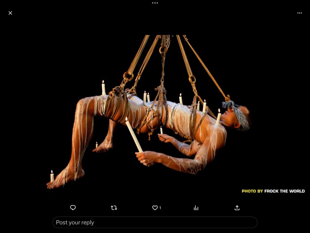 Man in a sling holding lit candles. Photo by Frock the World