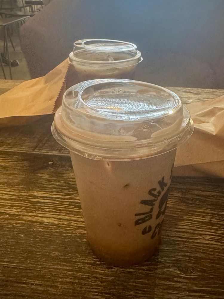 Two takeaway iced coffees from Black Sheep Coffee to commemorate the first time Rainstorm and I met in 2024 at this cafe