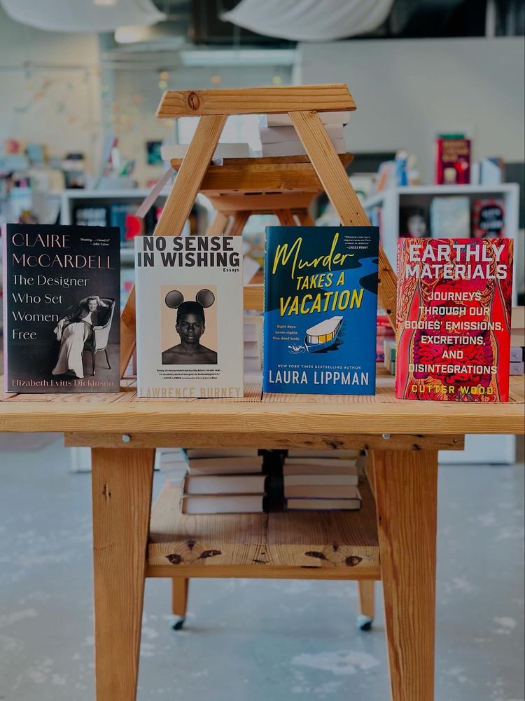 Four books lined up on the end of a bookstore table:
✨Claire McCardell: The Designer Who Set Women Free by Elizabeth Evitts Dickinson 
✨✨No Sense in Wishing by Lawrence Burney (out July 8 but available for preorder now!) 
✨✨✨Murder Takes a Vacation by Laura Lippman 
✨✨✨✨Earthly Materials by Cutter Wood