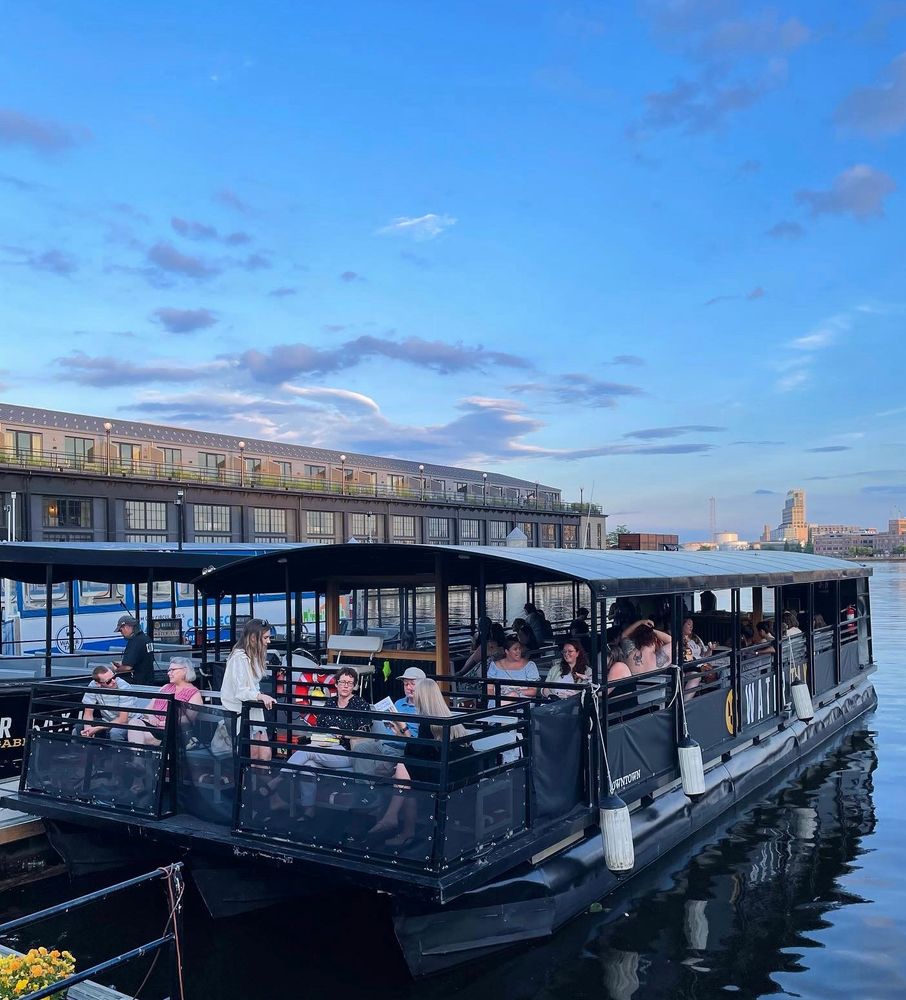 The Baltimore Water Taxi at dusk filling up for a sunset cruise and book swap