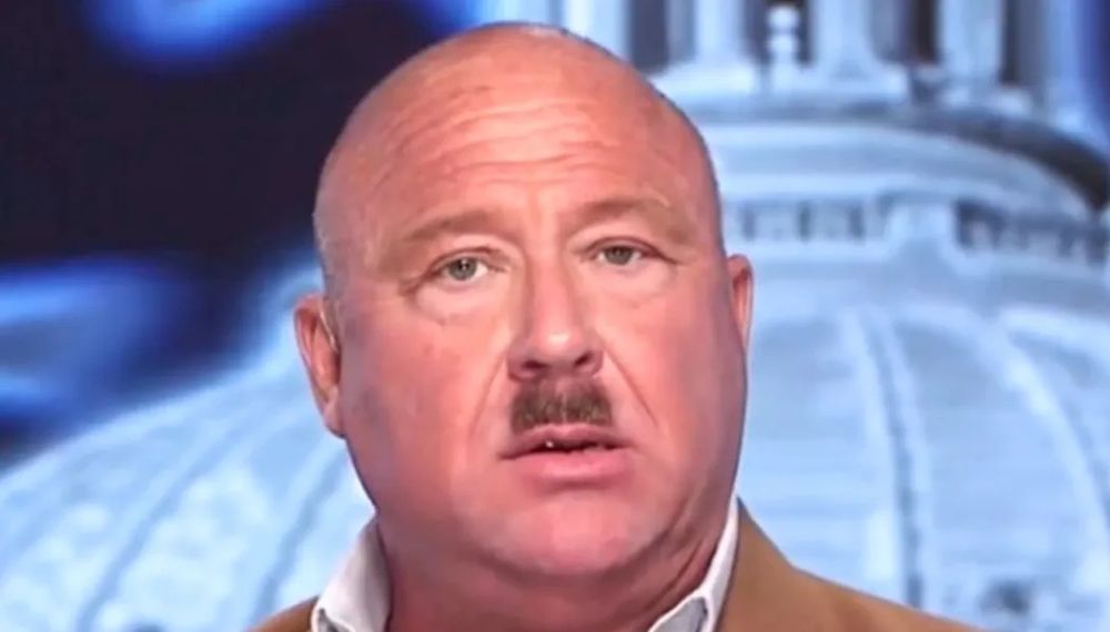 Bald round face with Hitler moustache. This personification of a moldy dumpling is Alex Jones.