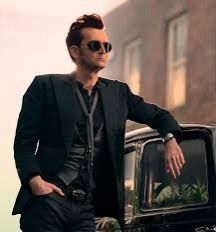 I'm sorry you can't see David Tennant as Crowley in Good Omens in a spiky auburn bouffant, steampunk sunglasses, and black emo three-piece suit with skinny silver-mesh scarf casually resting an elbow on his black Bentley.