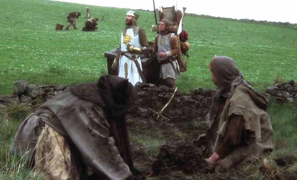 King Arthur rides by the constitutional peasants in a scene from a Monty Python film.