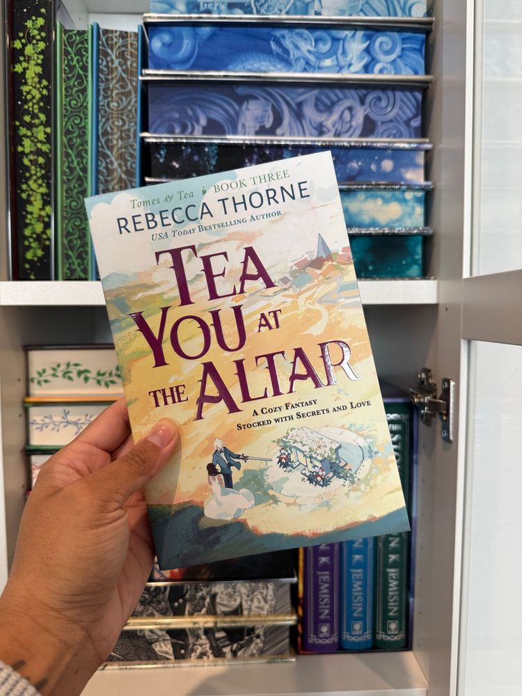 A hand holding Tea You At The Alter by Rebecca Thorne