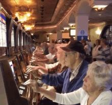 Old people at a casino repeatedly pressing the same buttons