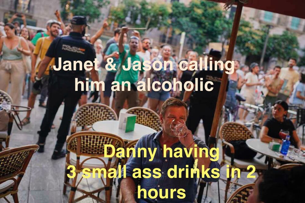 Photo of the anti tourist protest in Barcelona which depicts a tourist drinking peacefully while people behind him are yelling at him for being there