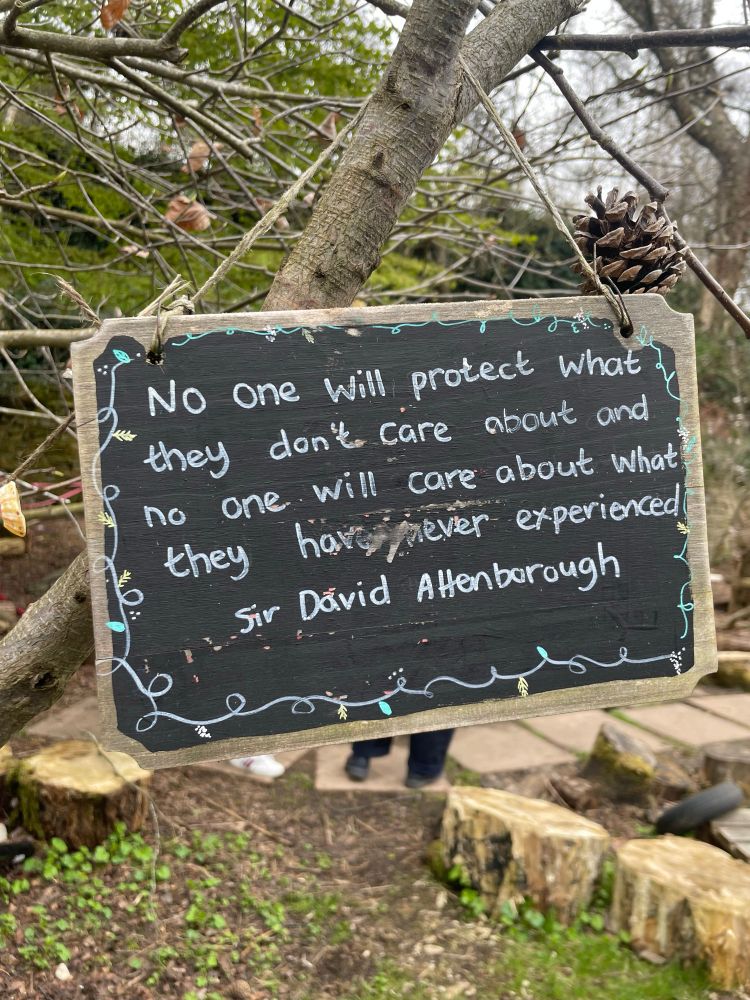 A small sign reading ‘No one will protect what they don’t care about and no will care about what they have never experienced, Sir David Attenborough’ 