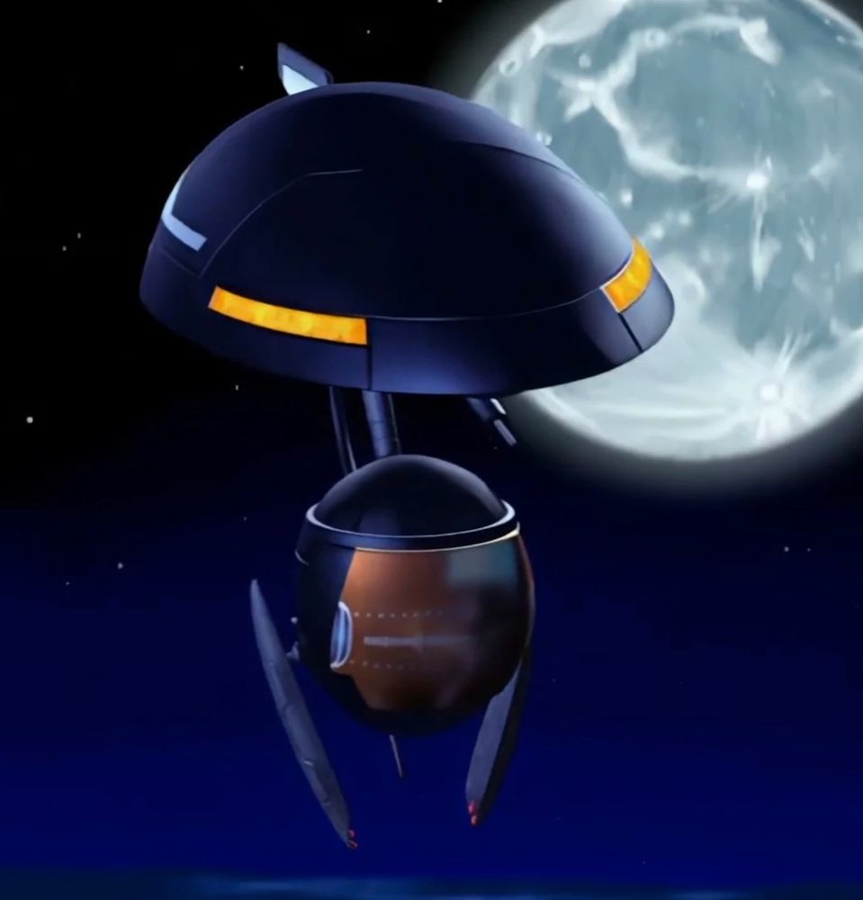 GIG, a floating robot character from the Hot Wheels: Acceleracers series. GIG has a navy blue dome-shaped head with orange eyes, and a spherical orange body with two small appendages.