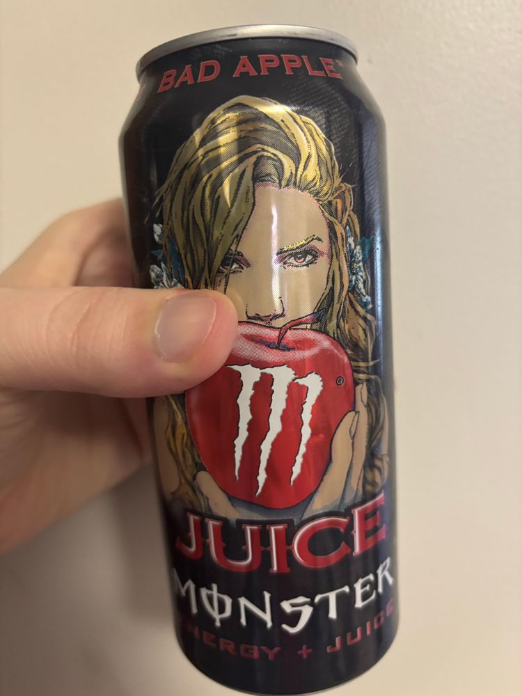 Me holding a can of Monster Juice Bad Apple Flavor 