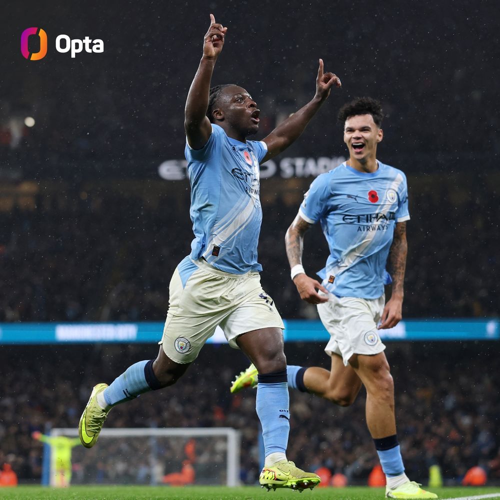 Jérémy Doku celebrates his goal v Liverpool with arms in the air.