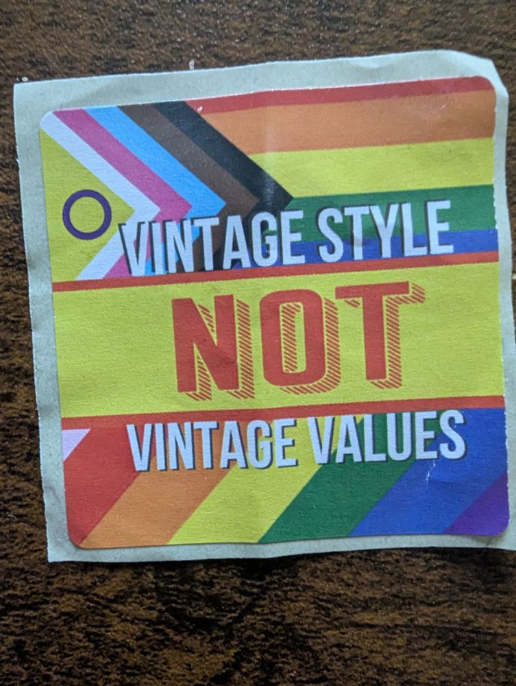 A sticker that says "vintage style ,not vintage values " on a backgr of a full inclusive LBGTQIA+ flag 