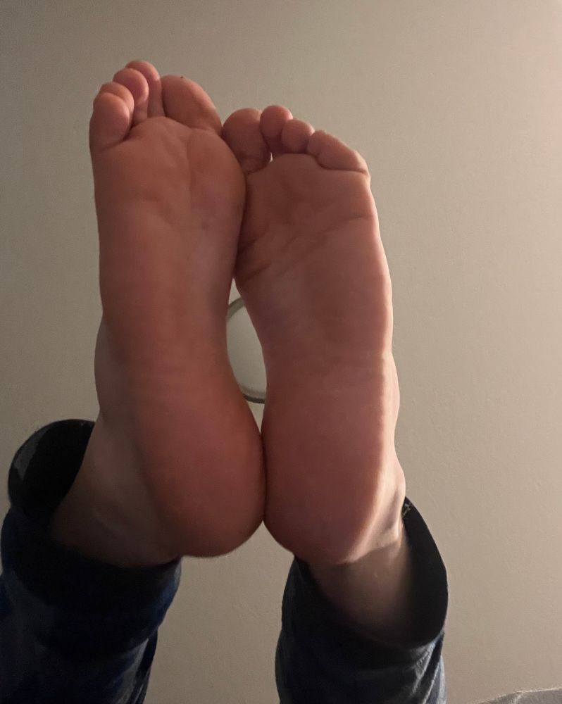 Soles in the air above the camera, with a ceiling light visible between them