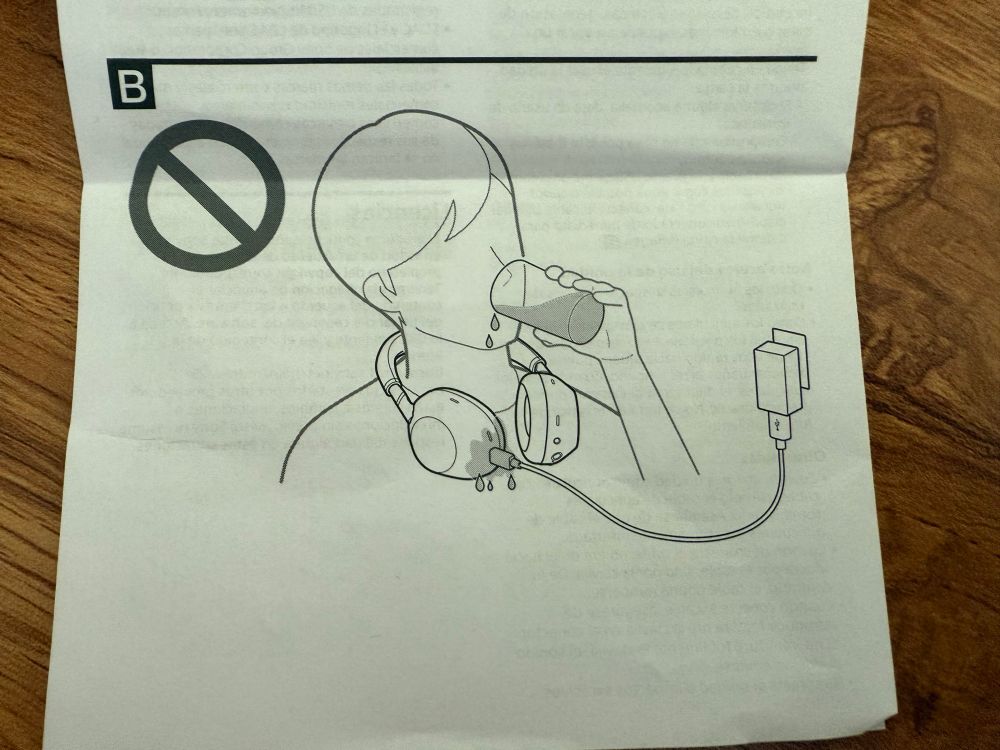 Picture from a headphones user manual of someone drinking like a messy bitch and spilling their drink on the plugged in headphones