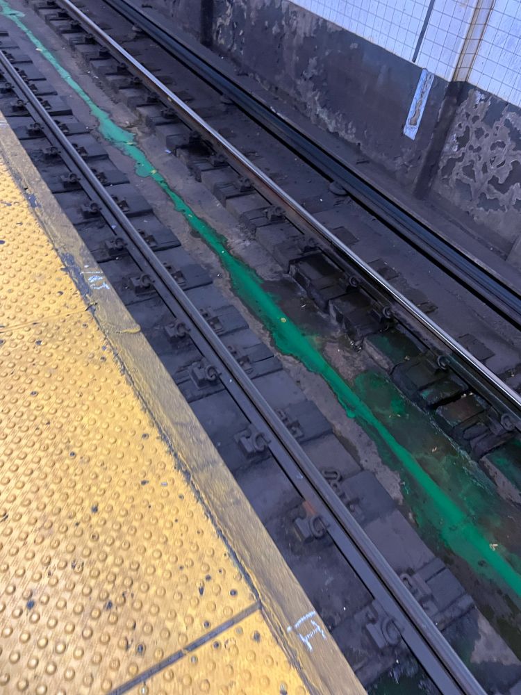 Green fluid in subway tracks 
