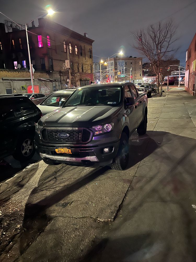 pickup truck parked on sidewalk 