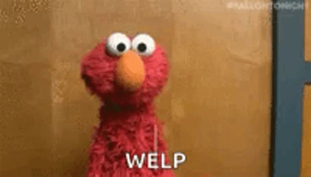 elmo from sesame street is standing in front of a brown wall and says welp .