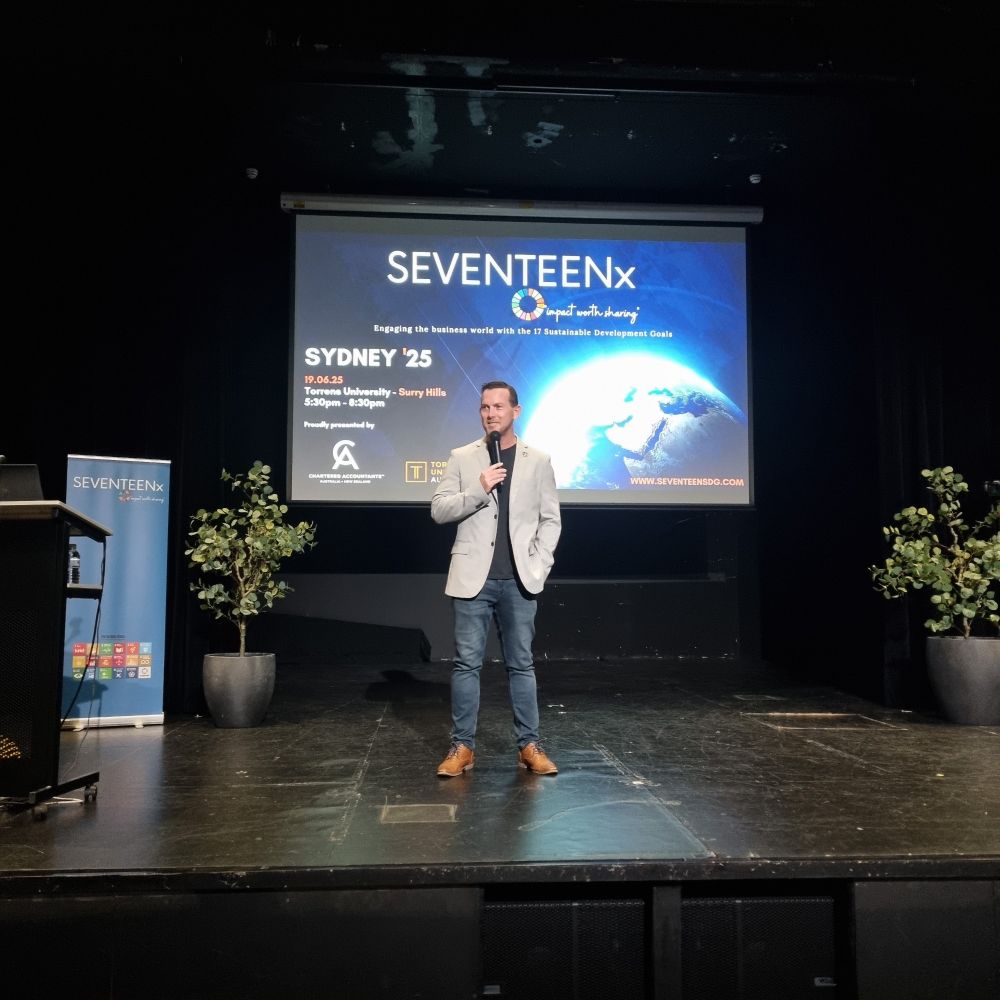 Founder of SEVENTEENx Mick Hase on stage kicking off the event. 