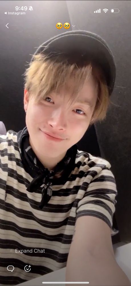 Hongjoong smiling cutely with a closed mouth