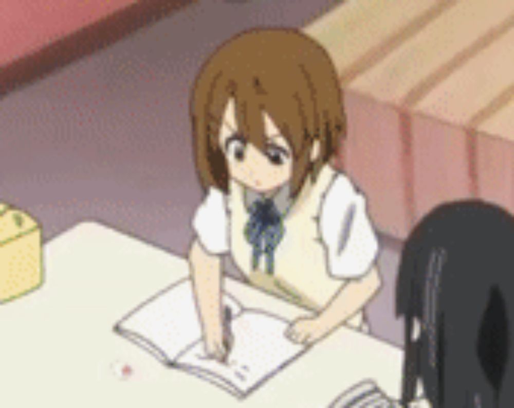 a girl in a school uniform is sitting at a table with a notebook .