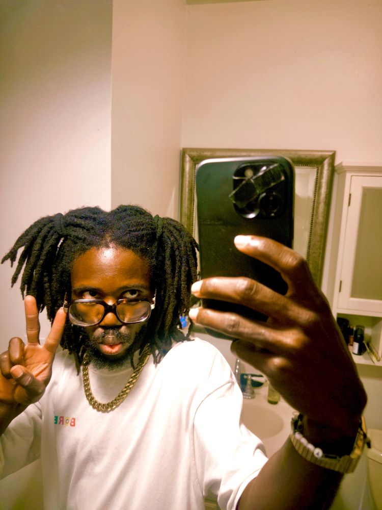 JER throwing up a peace sign while taking a mirror selfie 