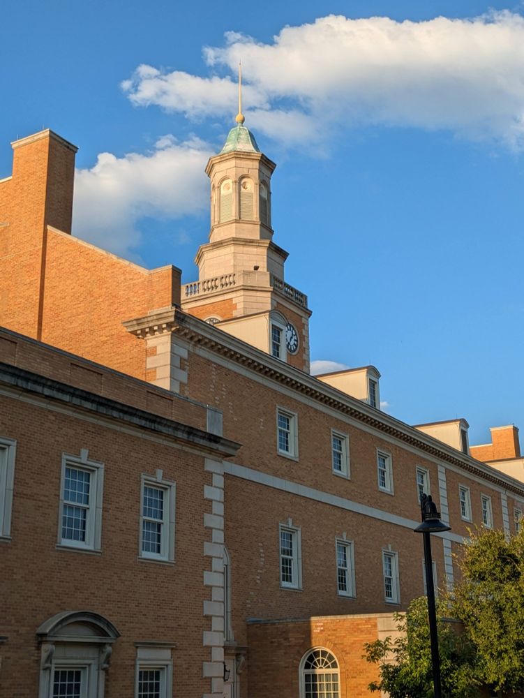 A side photo of the Hurley administration building with clouds above the clock tower