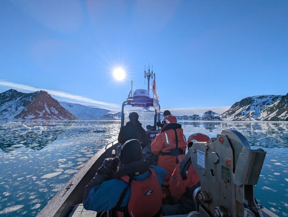Researchers on a multi-role rescue boat in Antarctica, heading towards a glacier.