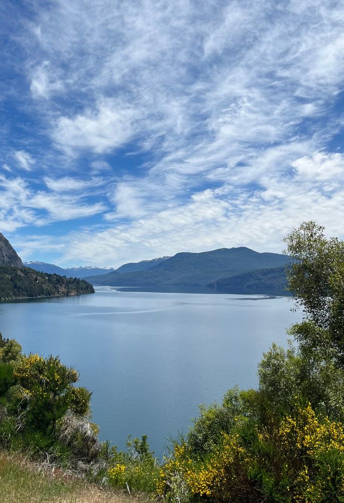 picture of a lake and mountains on a sunny slightly-cloudy day
