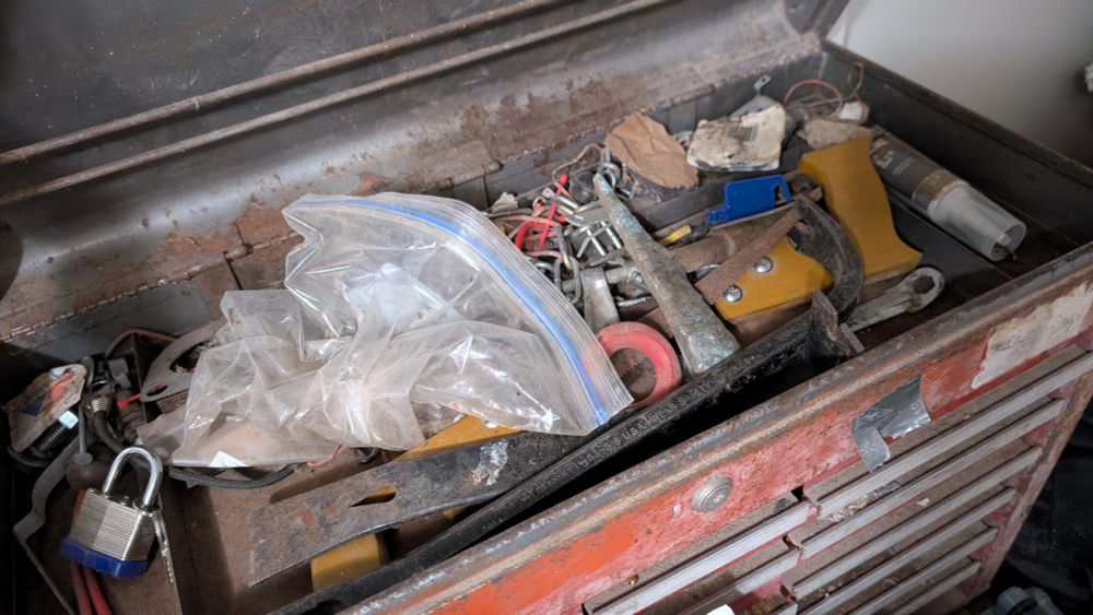 Jex's dad's old toolbox. It is rusty and disorganized. You can't see inside all the various little drawers, but if you could, you'd see that they're really gross inside. 