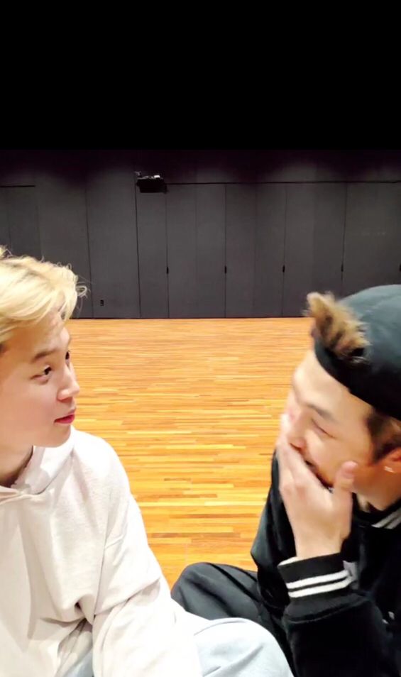 Park Jimin tries very hard to keep his face neutral and not stare daggers at his bandmate Joon, after he again lets something slip and laughingly covers his mouth