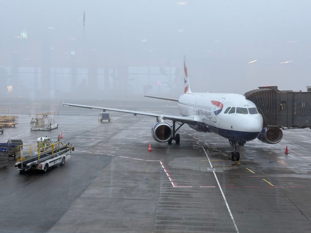 Picture of an British Airways plane on the ground on a foggy morning.