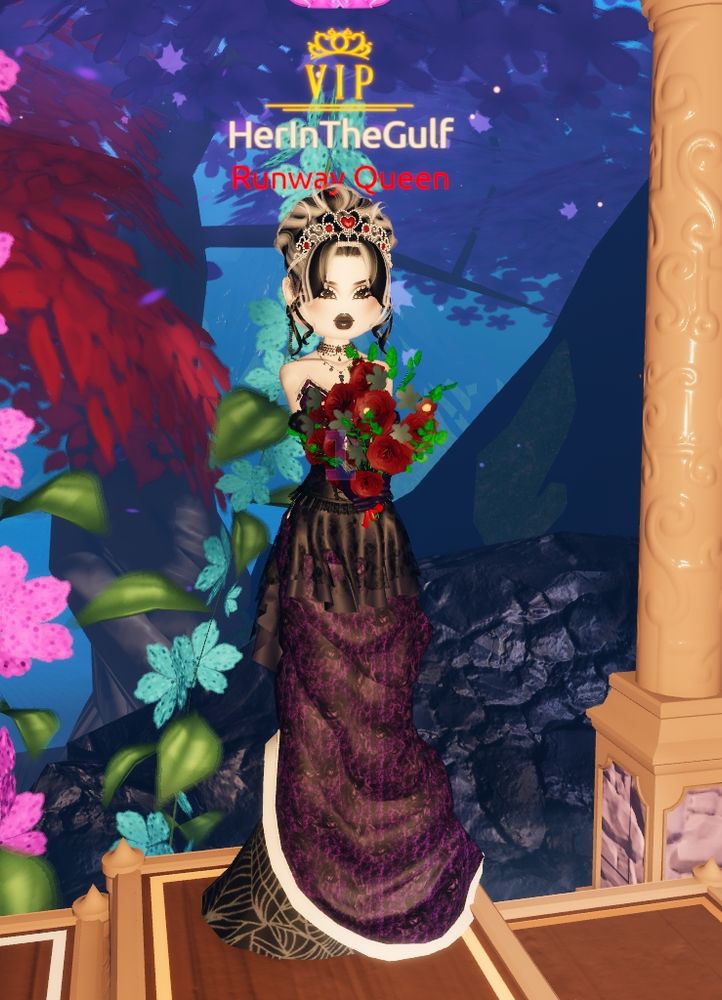 The dress to impress character model is standing on the 1st place podium. She is wearing a deep purple, floor length dress with various layers of detailing. One of the layers visible uses a black and white spider web pattern. There is another thin layer of a white material. The character model is paler than usual, to match the gothic white makeup. She has black and white streaked hair which is in the messy bun style. Her hair is adorned with a white crown with red jewels on it. She has two black necklaces and a pair of long, dangly black earrings. She is holding a bouquet or flowers which are coloured with desaturated red, blue and green to give a gothic vibe.