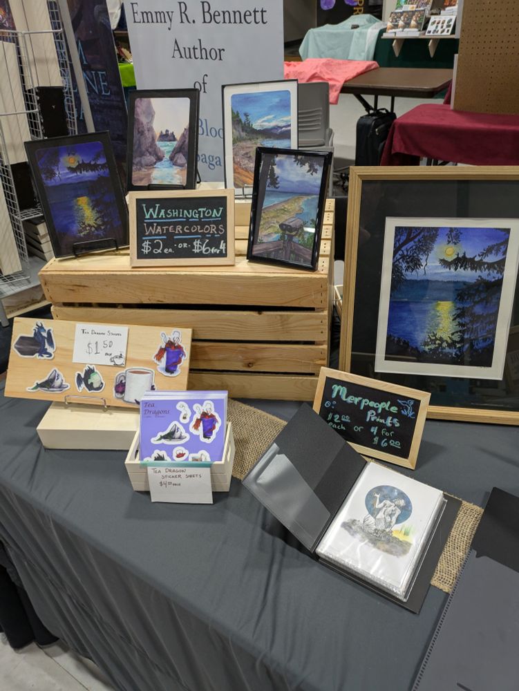 Photo of my table it  where you cans see of my teadragon stickers and  prints of original watercolors of the Olympic peninsula