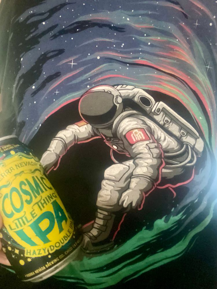 "Into the AM" astronaut surfing the star filled sky with a "Sierra Nevada Cosmic Little Thing IPA" in front of the barrel.