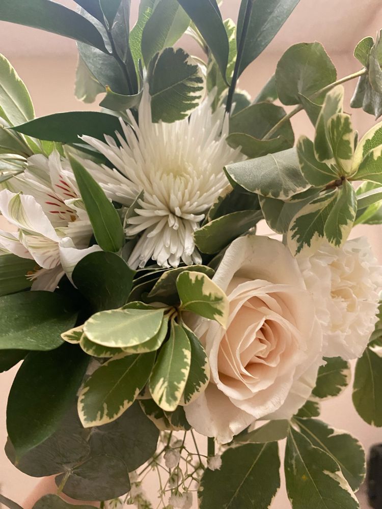 My bridesmaid bouquet for my sisters wedding. It has 4 different white flowers, as well as baby’s breath and greenery. 