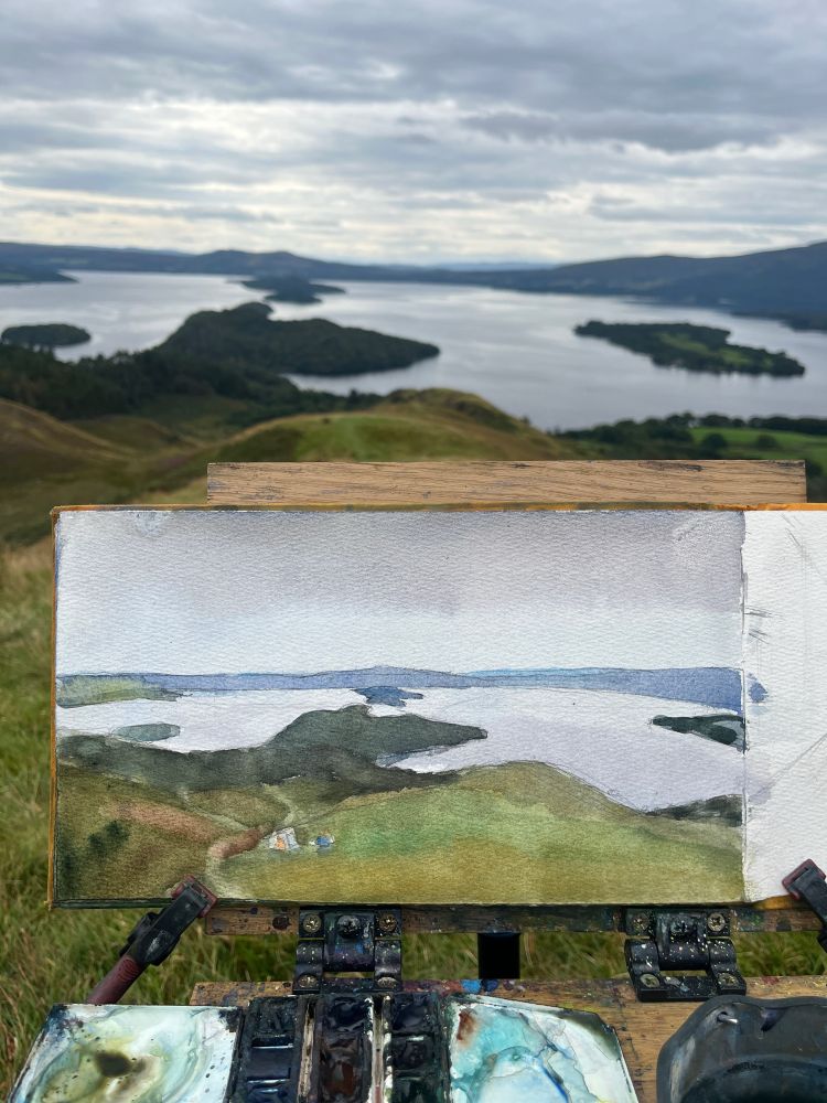 Watercolour of a loch with islands covered in trees from the view point of a hill