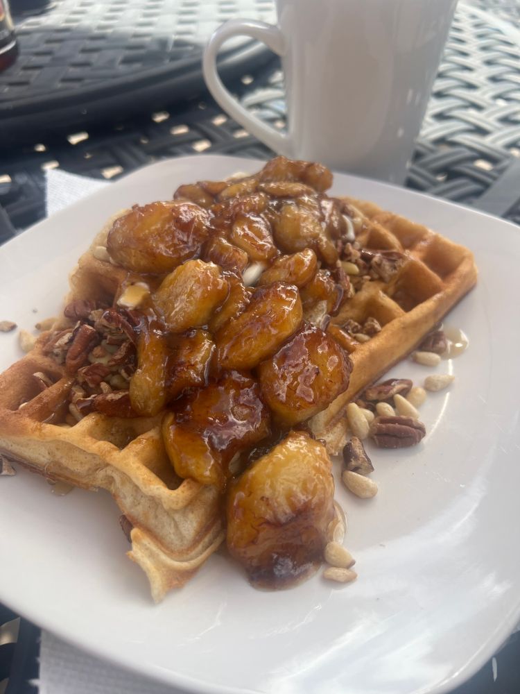 Waffles with a banana and nuts flambe. Coffee.