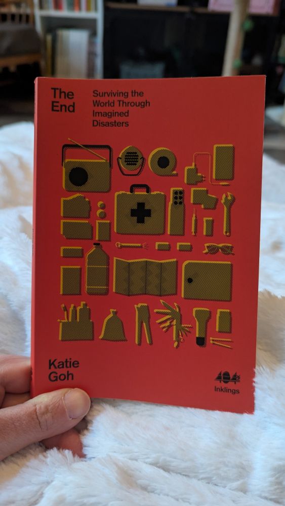 The End: surviving the world through imagined disasters by Katie Goh.

A red cover featuring a stylised illustration of items in a survival kit