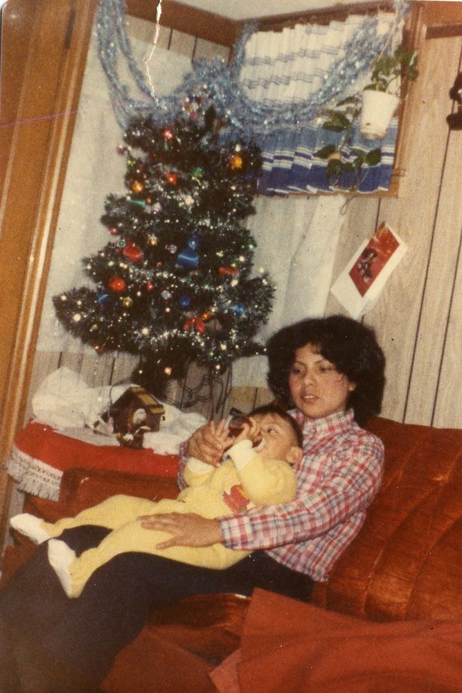 Old baby photo of Daniel on his mom's lap.