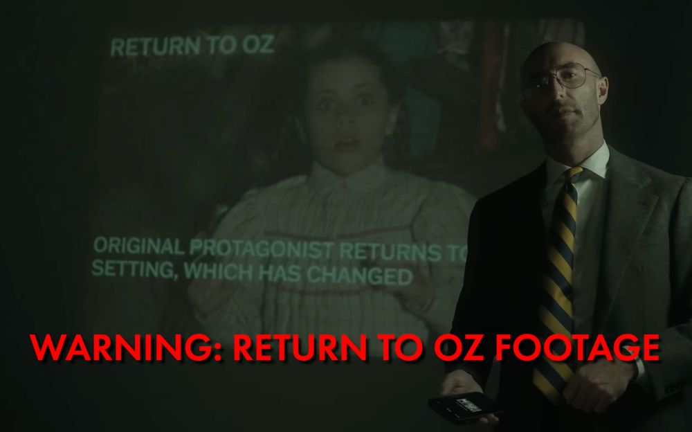 Screenshot from "Anatomy Of A Legacy Sequel" by Patrick H Willems. 

The host stands in front of a projector screen with a still frame of a shocked Dorothy Gale, frightened by something off-screen. The red all-caps overlay text reads "WARNING: RETURN TO OZ FOOTAGE"