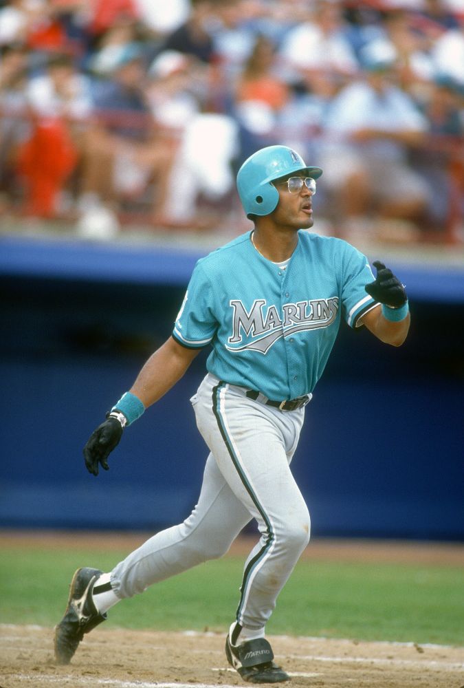 orestes destrade at the plate with teal marlins uniform and glasses with silver rims that match the jersey lettering